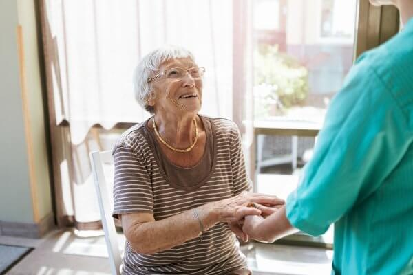 Elderly person with Dementia helped by nurse