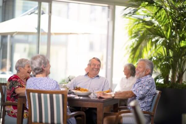 Senior Friends at a Meadowbank Cafe discussing and eating